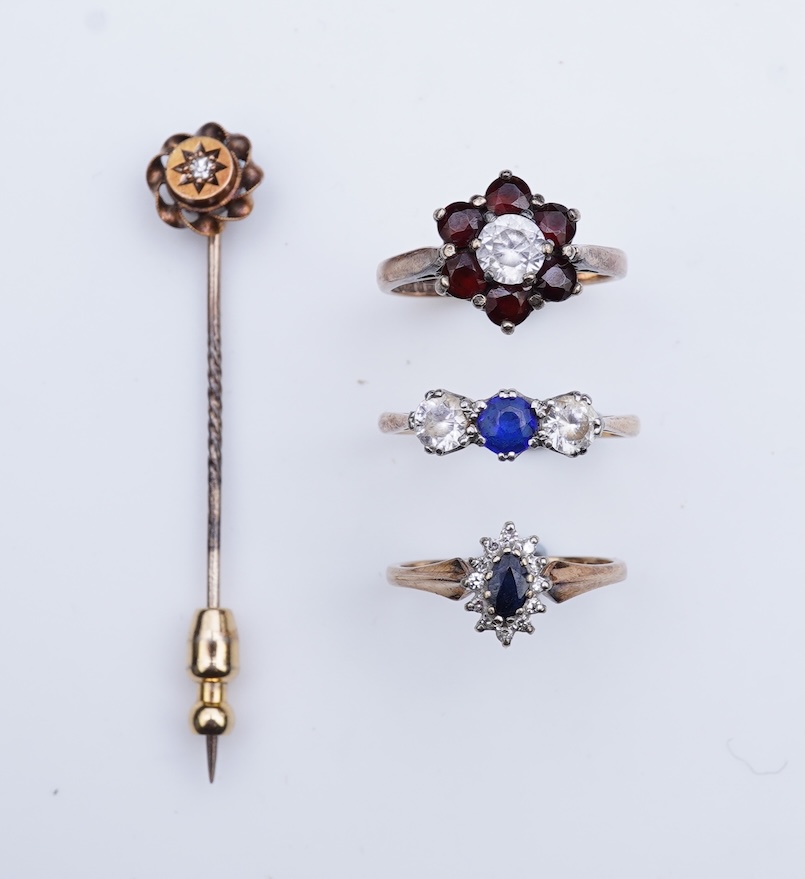 A group of three rings and a tie pin